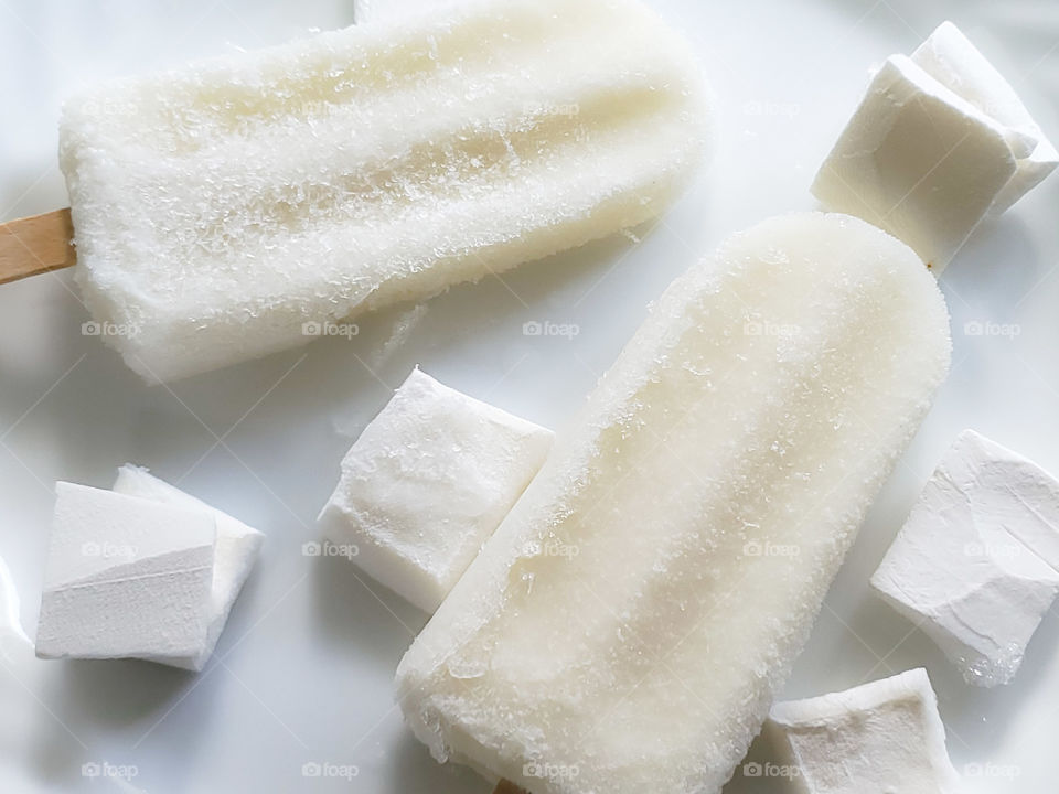 Coconut ice cream popsicles and coconut meat chunks