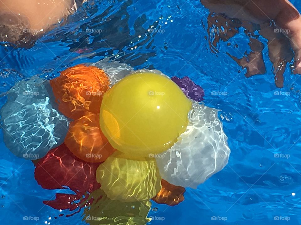 Water balloons floating . Floating water balloons in swimming pool