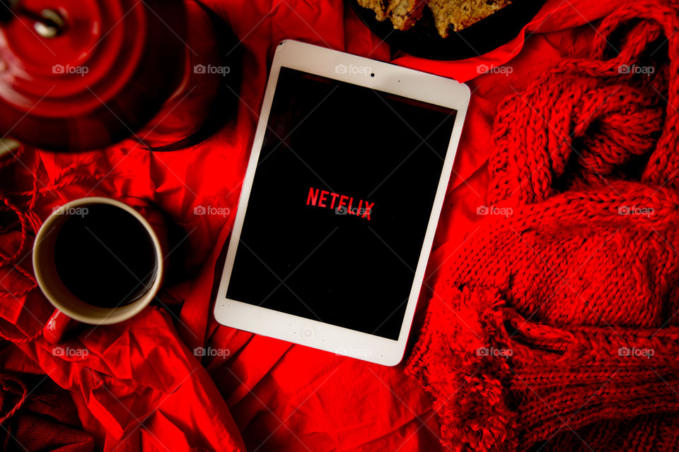 Netflix in winter with coffee eats scarf and gloves