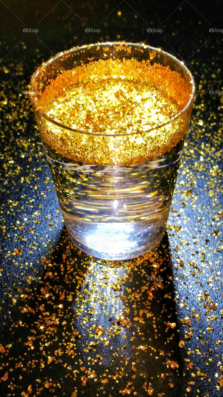 gold floating in shot glass