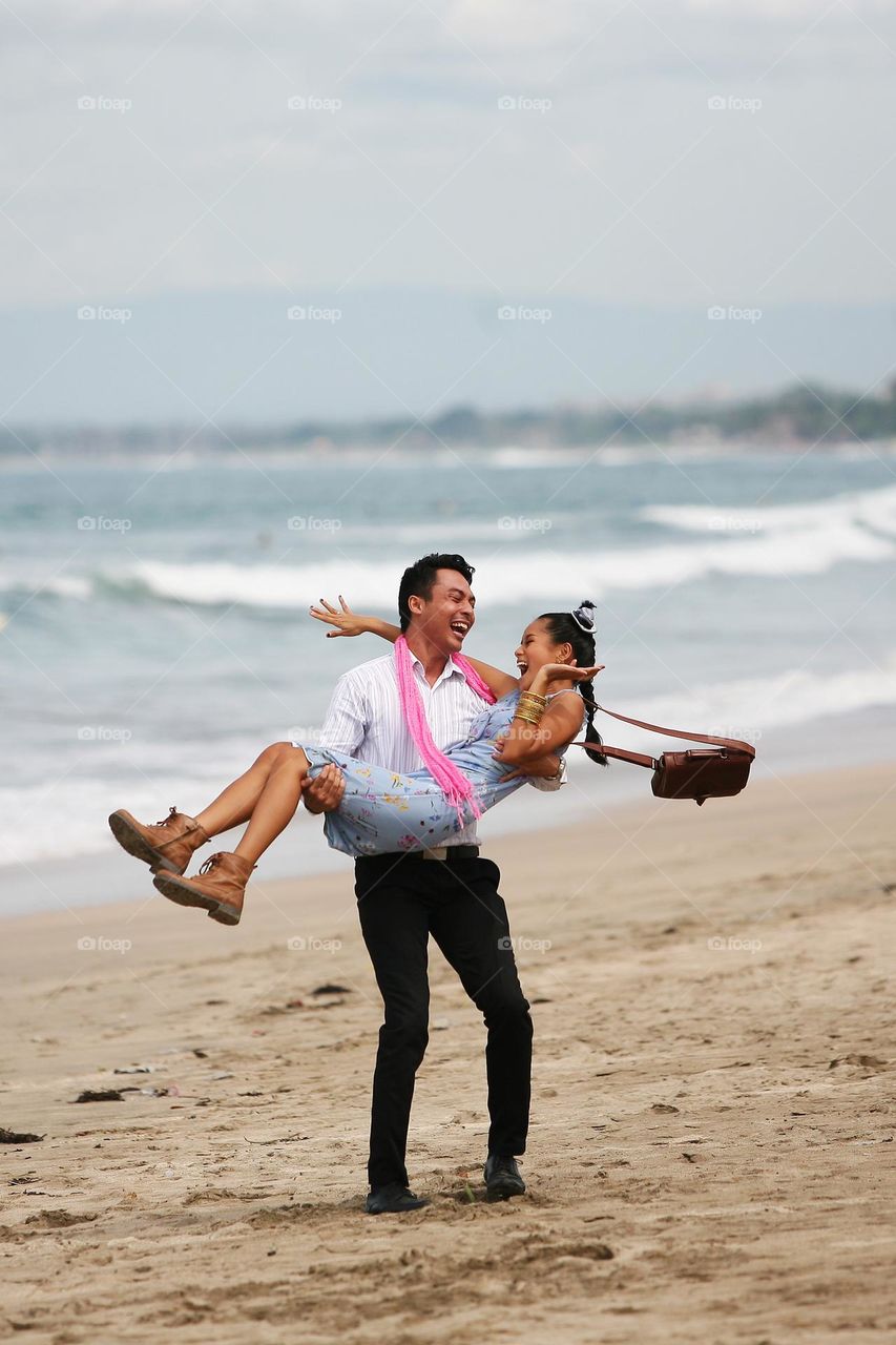 Happy couple on the background of a beautiful sea landscape