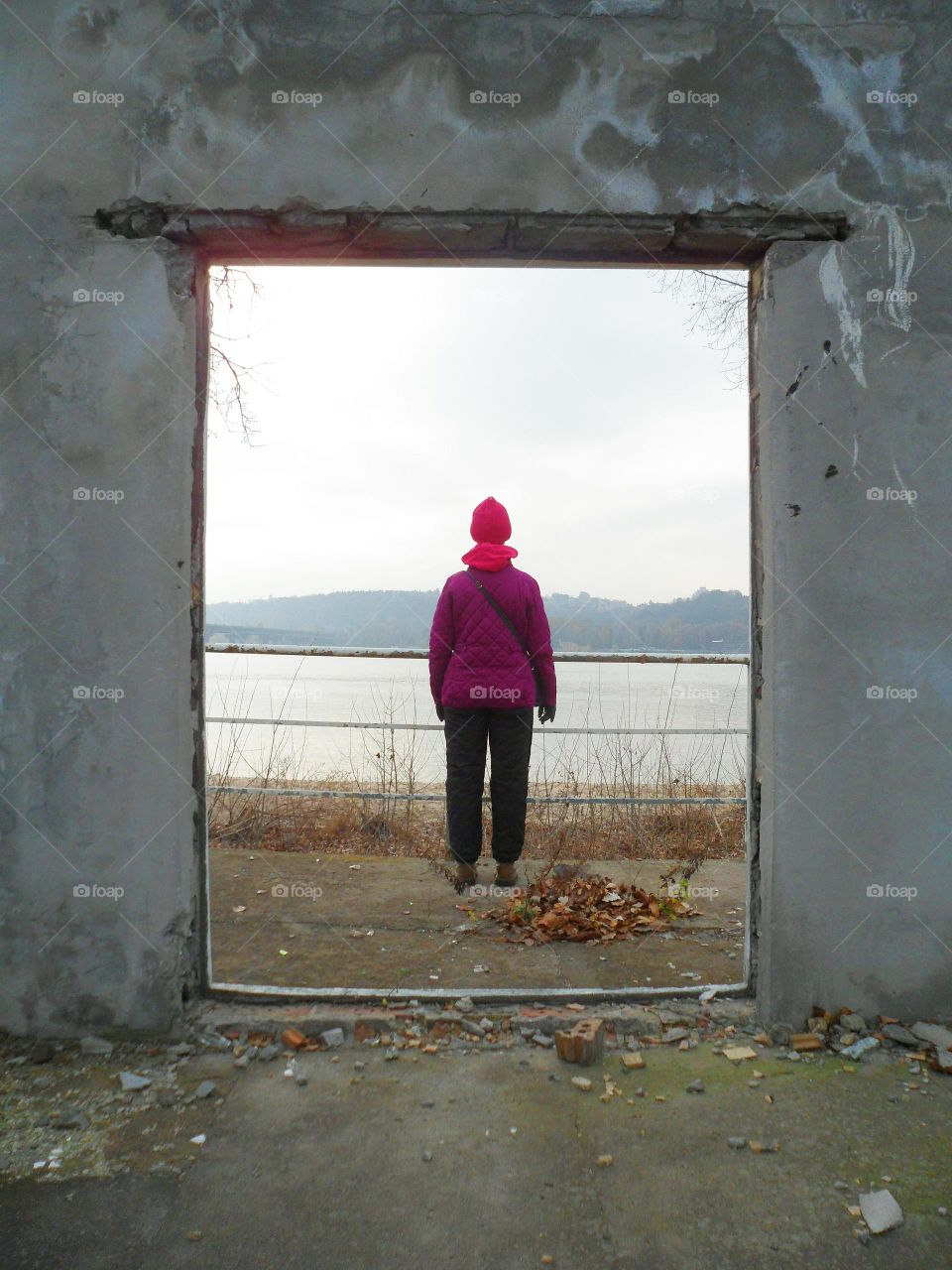 the girl in the doorway of an abandoned building