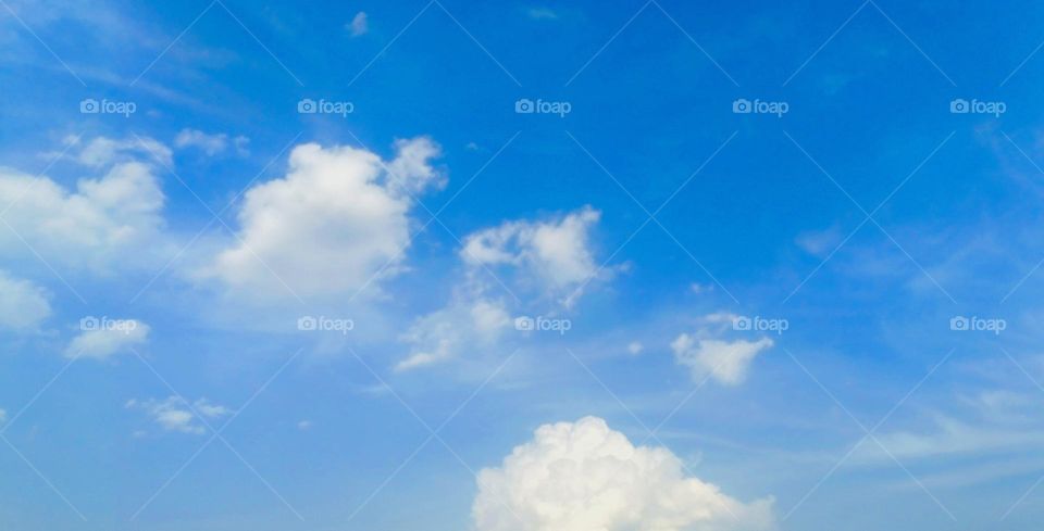 Dark blue sky with white clouds