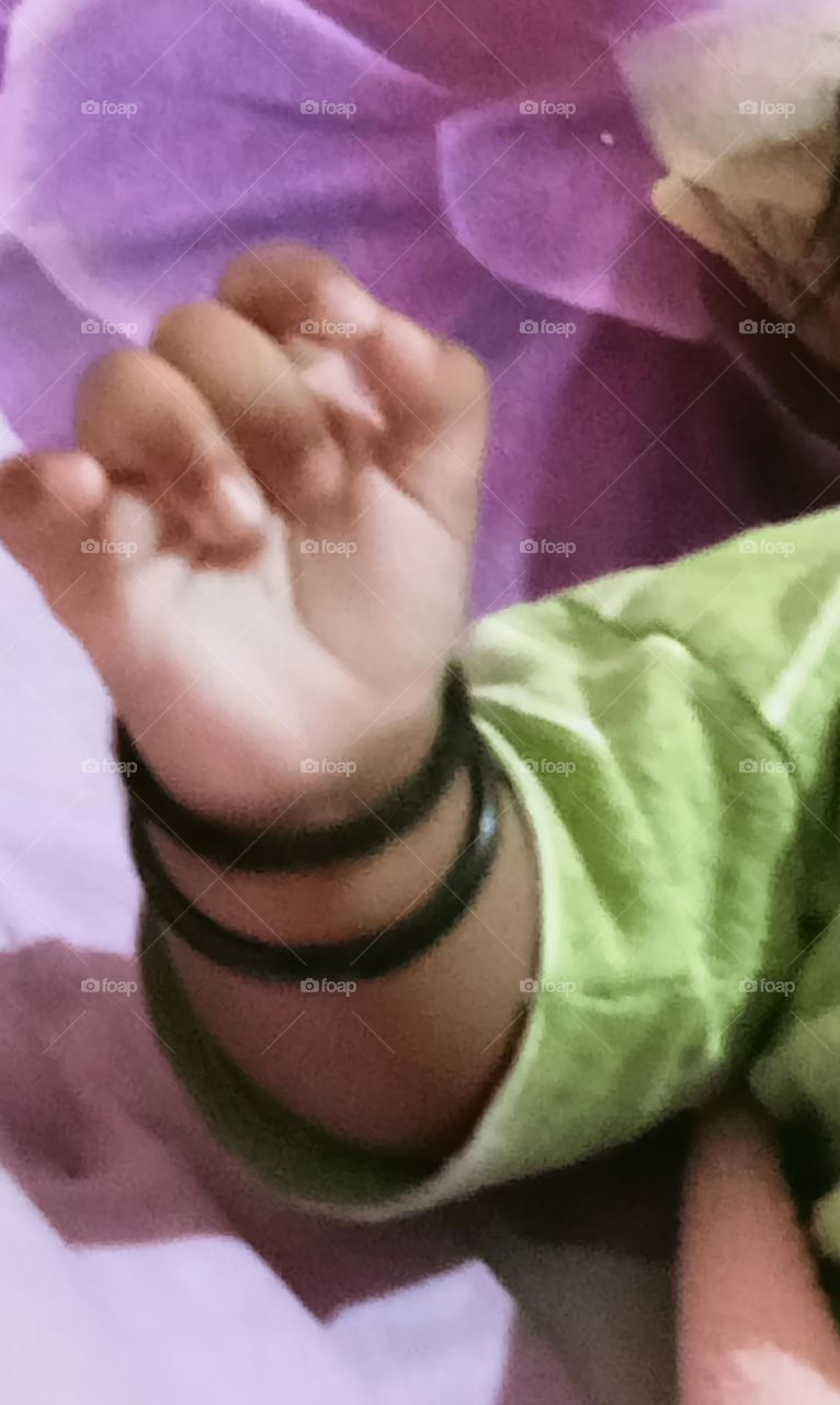 This beautiful ❤️😍 hand of two month's baby girl 🐥😍. Baby is sleeping in her bed and playing joyfully with her toys!!🪀🧸