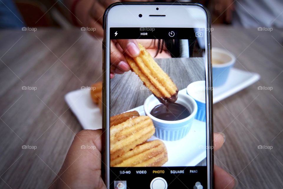 Person taking a photo of food in Smartphone