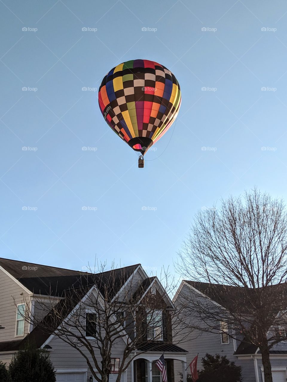 hot air balloon through neighborhood