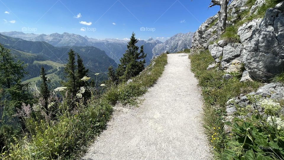 Hiking trail trail in the alps with stunning landscape view of mountains in summer, Schönau am Königsee Germany 