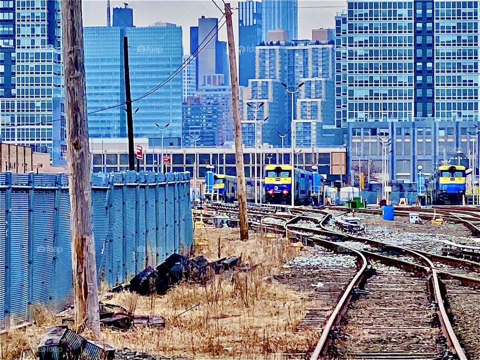 Train tracks underneath the Pulaski Bridge in LIC, Queens, NY every pedestrian has to cross before ascending the red metal staircase leading up to the bridge. 2021. Hypnotic Productions