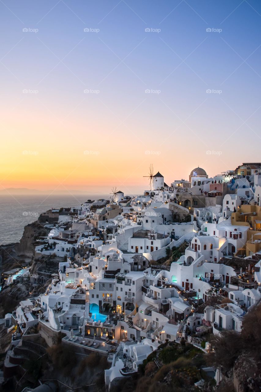 Brown and white houses beside sea during day time