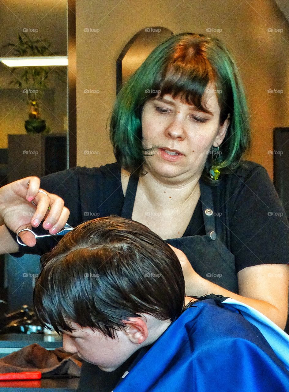 Childhood Haircut. Young Boy Getting A Haircut
