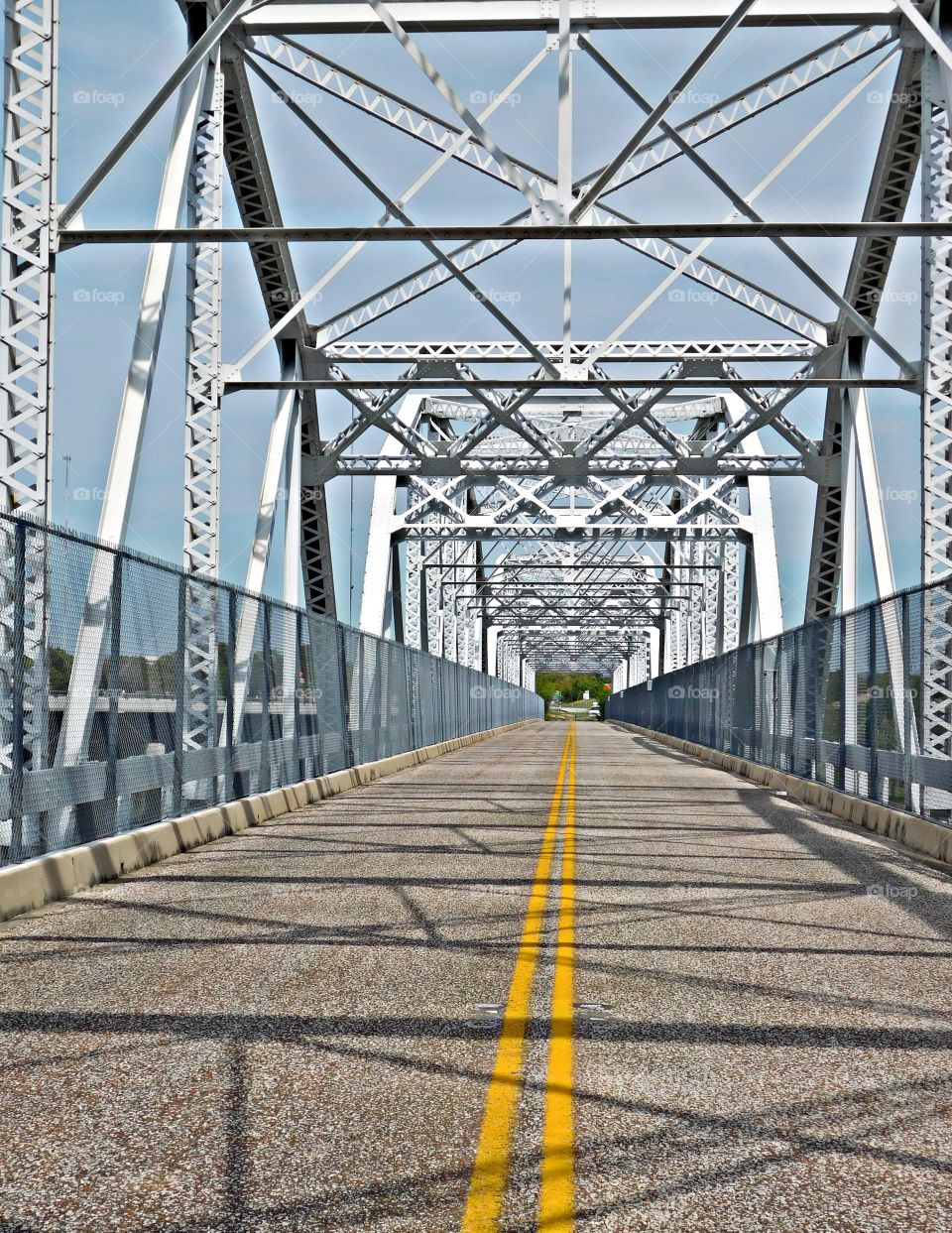 Symmetry - Bridge with yellow stripe on the roadway. Symmetry is important in bridge design because the entire length of the bridge must be able to bear