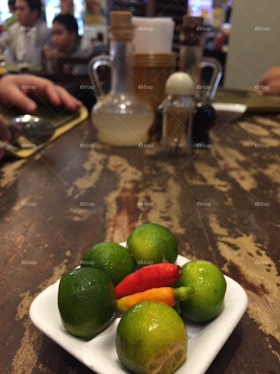 Not all condiments are equal. In the Philippines, it isn't salt and pepper or even ketchup and mustard. It's fresh calamansi and small hot peppers.