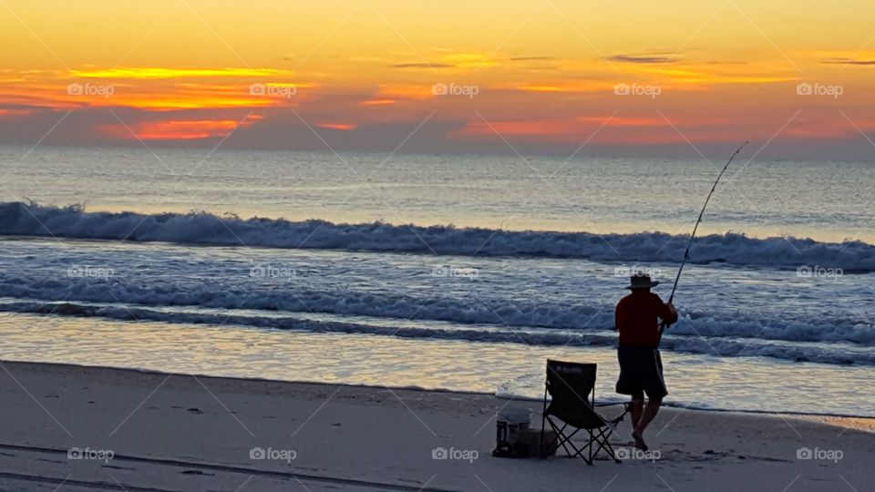 fishing on the shore at dawn
