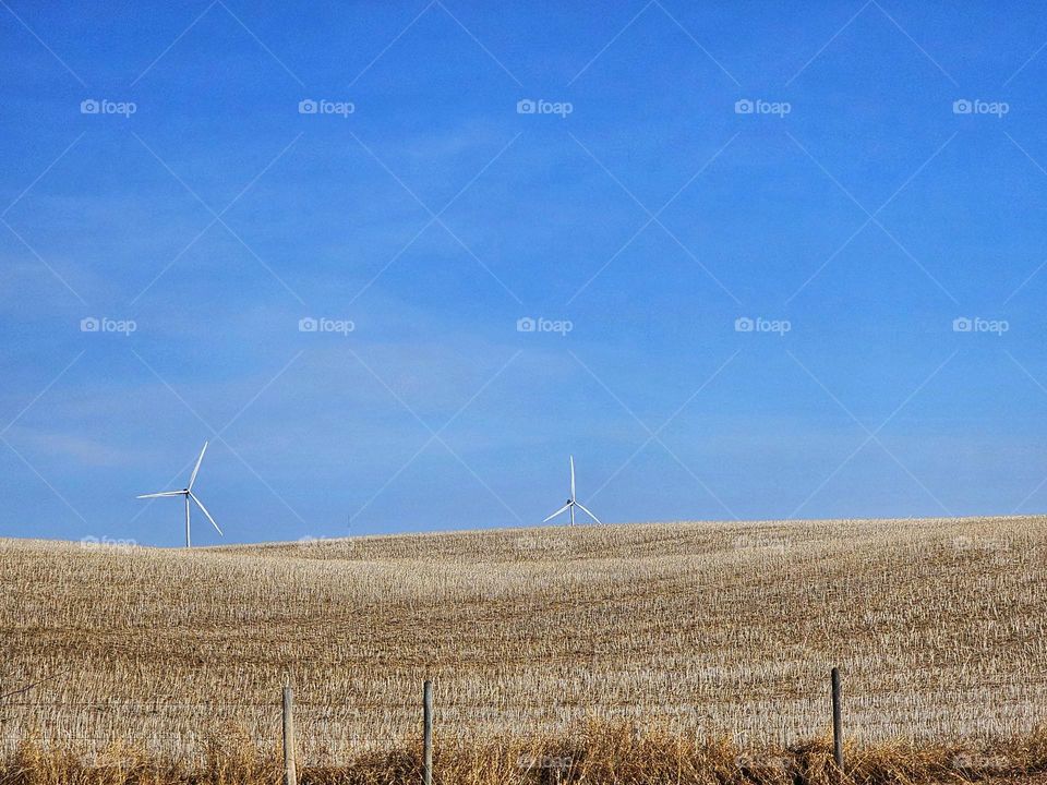 Wind turbines generating solar energy over the Alberta landscape