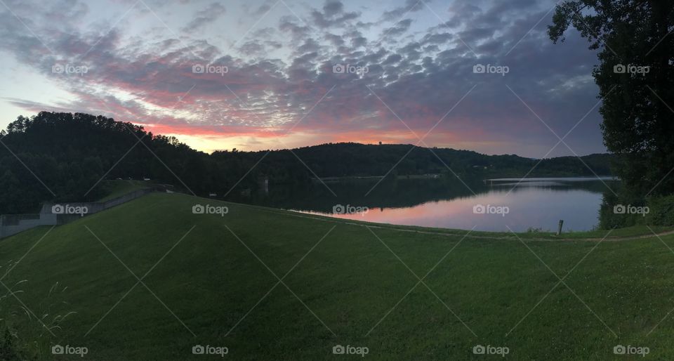 Panorama of a pink and blue sunset over a lake