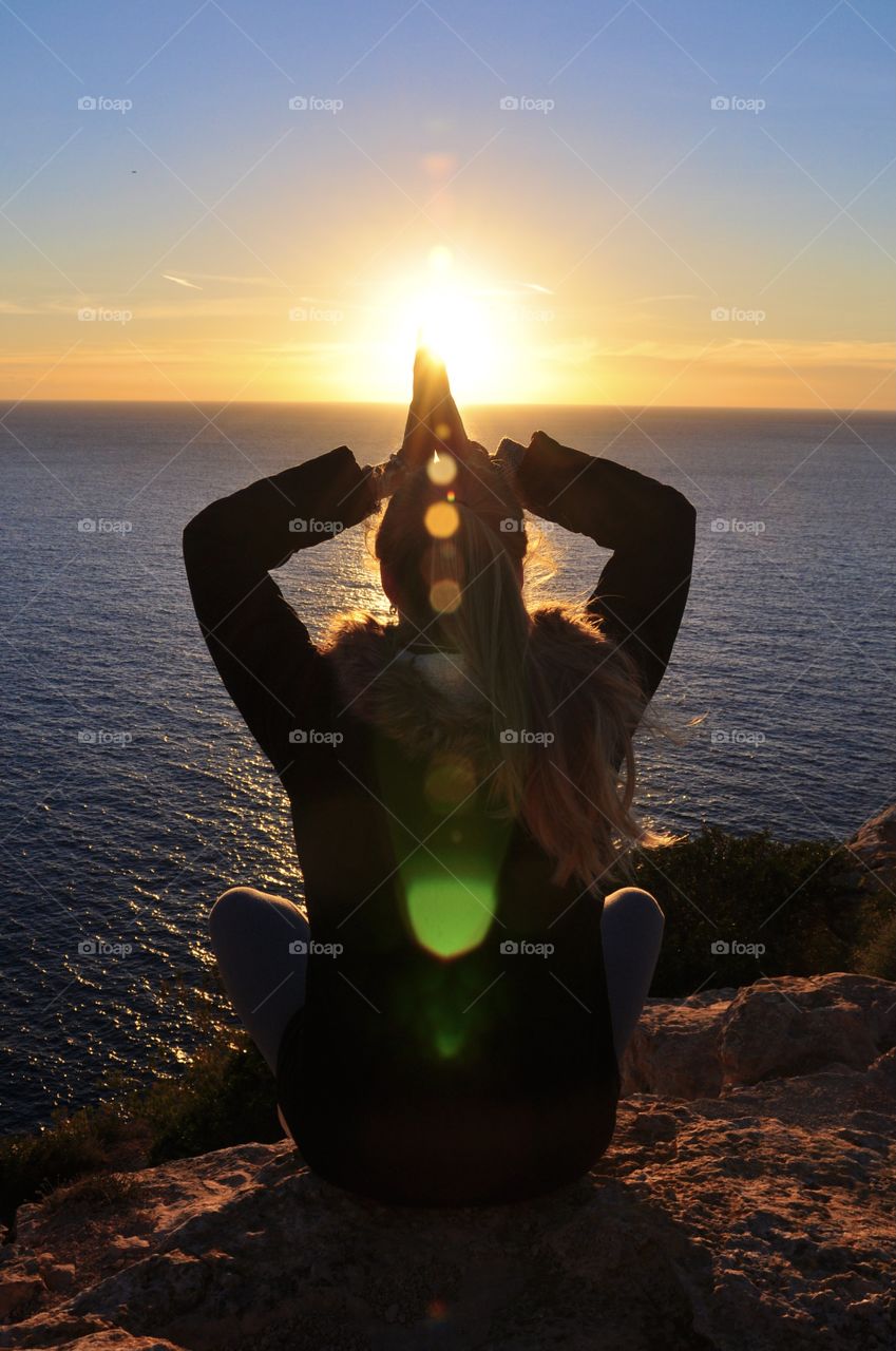 woman contemplating the sunset