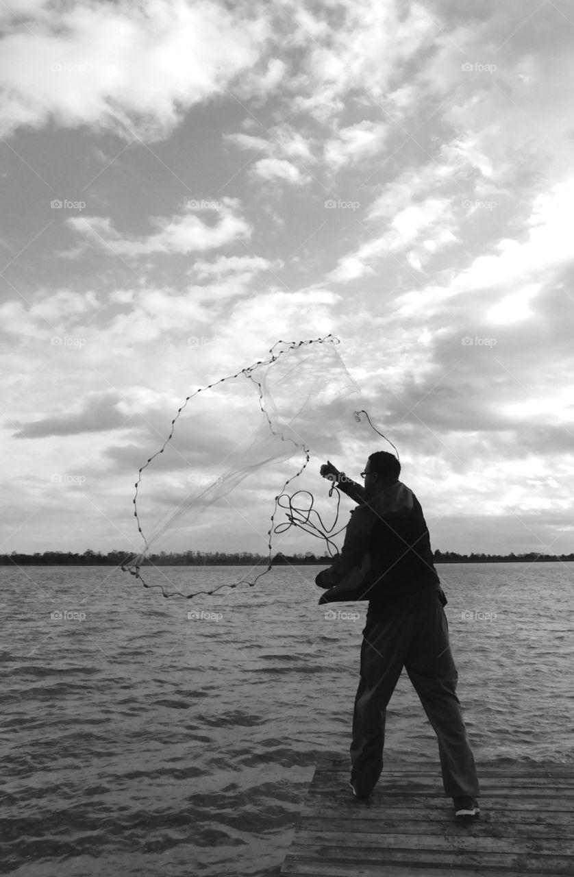 Happy Grey Story: A fisherman casts his net for the catch of the day! My Happy Grey Story photos shows cool, neutral,  and balanced color which             
communicates some of the strength and mystery of black!
