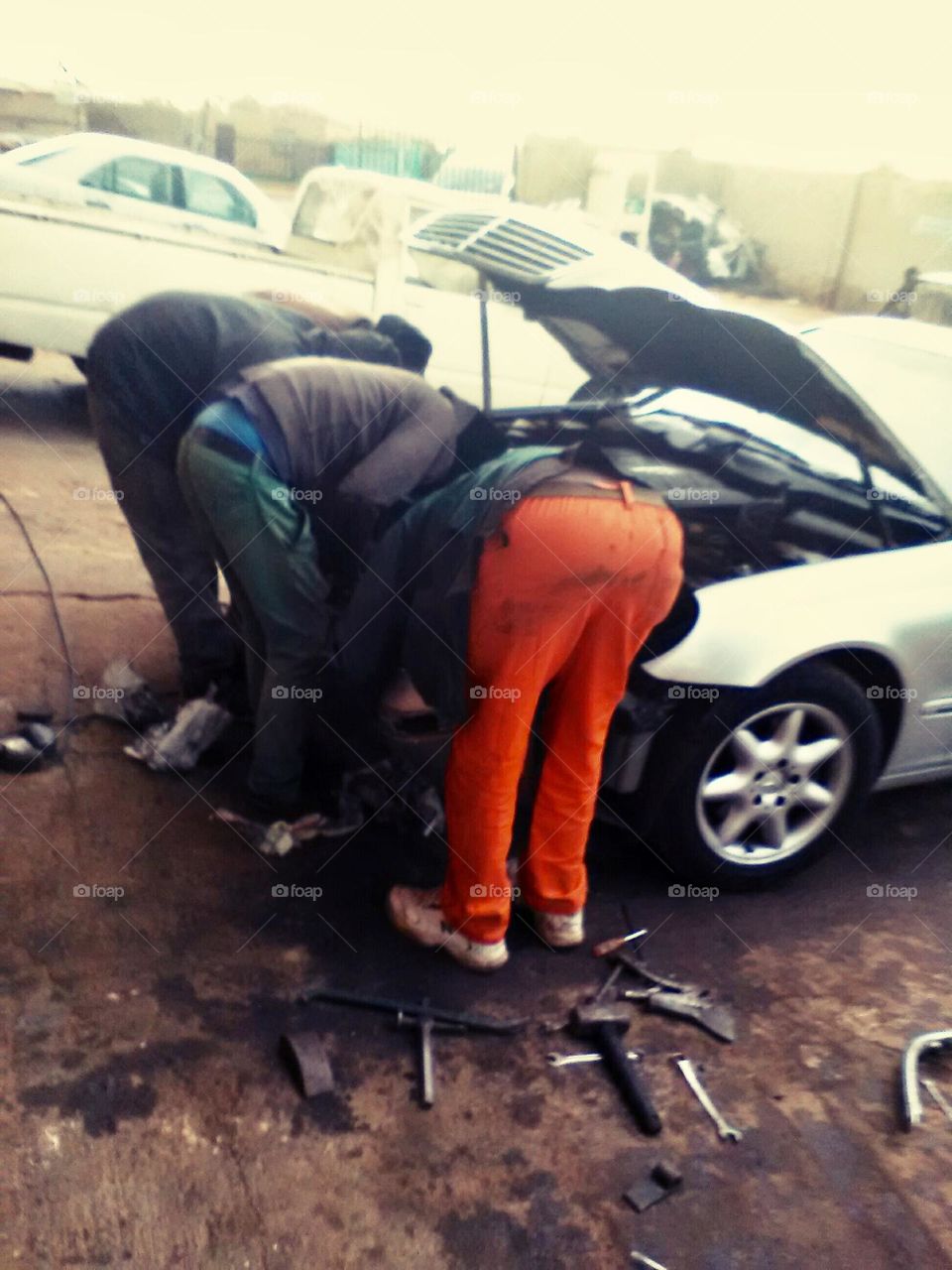 Men repairing a car 