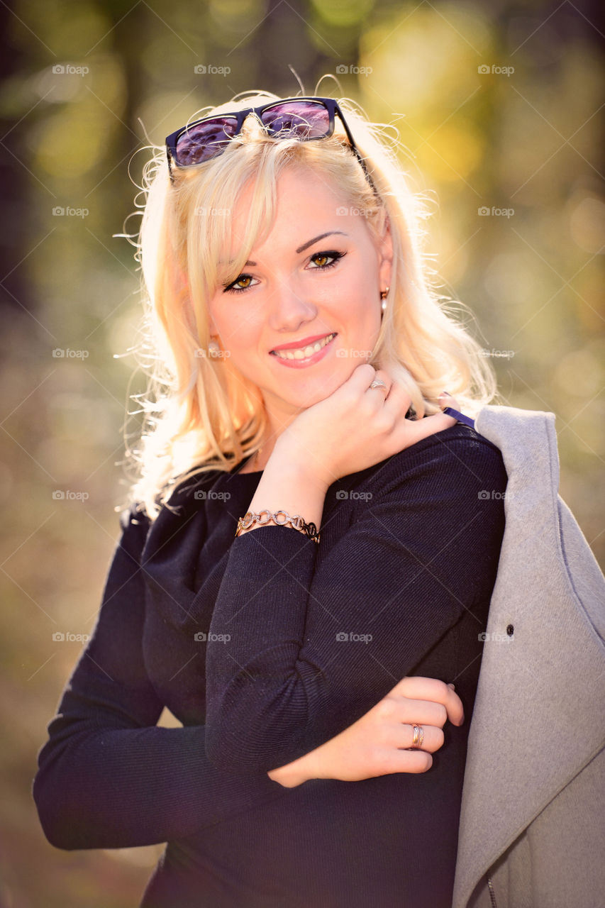 blonde smiling woman at sunny autumn day