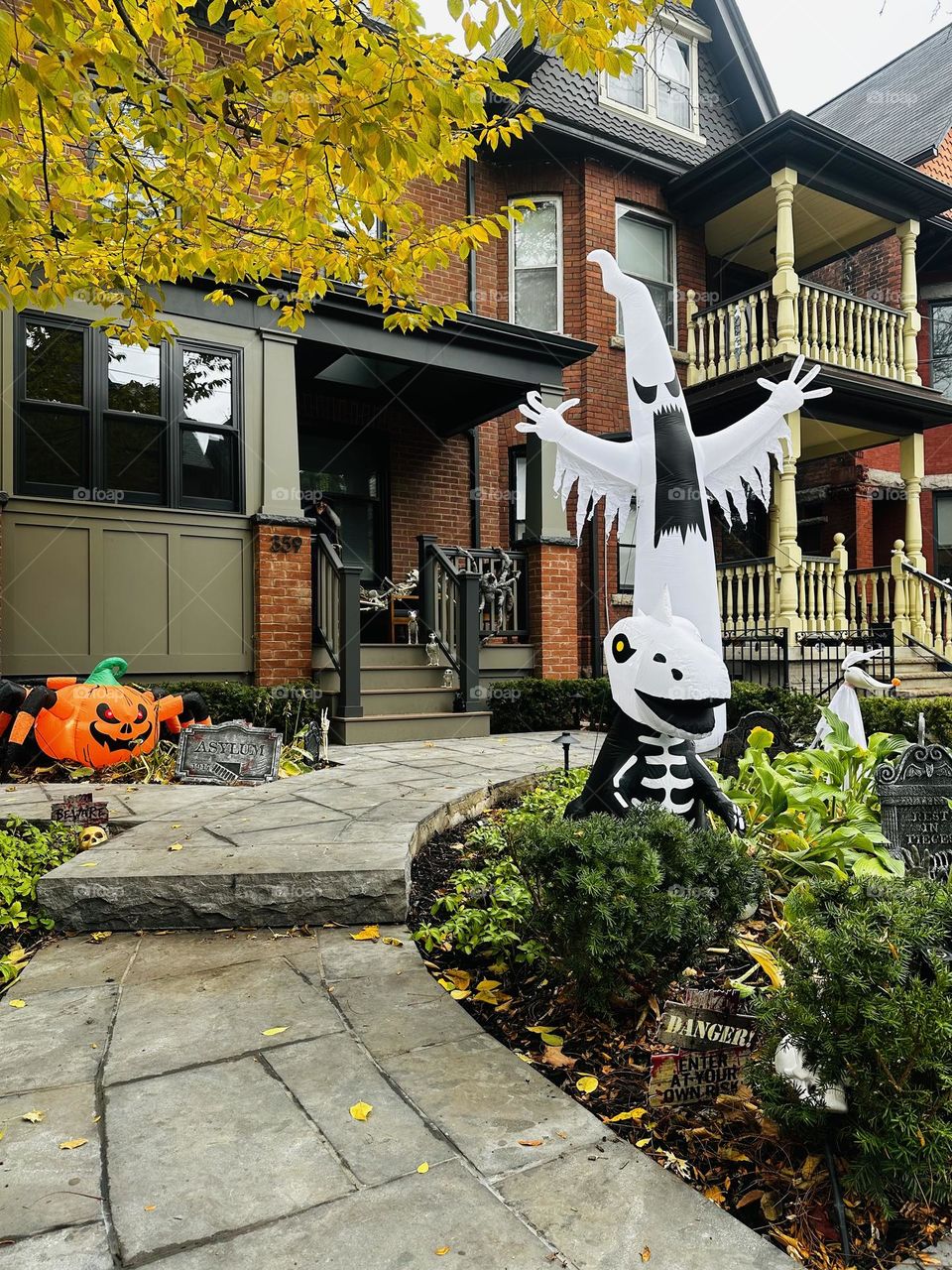 Halloween decorations and celebration in Toronto, Ontario. Ghosts, witches and skeletons. Creative art. Autumn, fall city landscape.