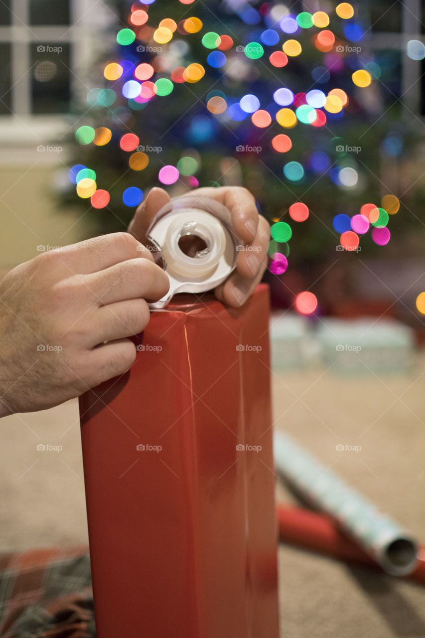 Man Wrapping a Christmas Gift 