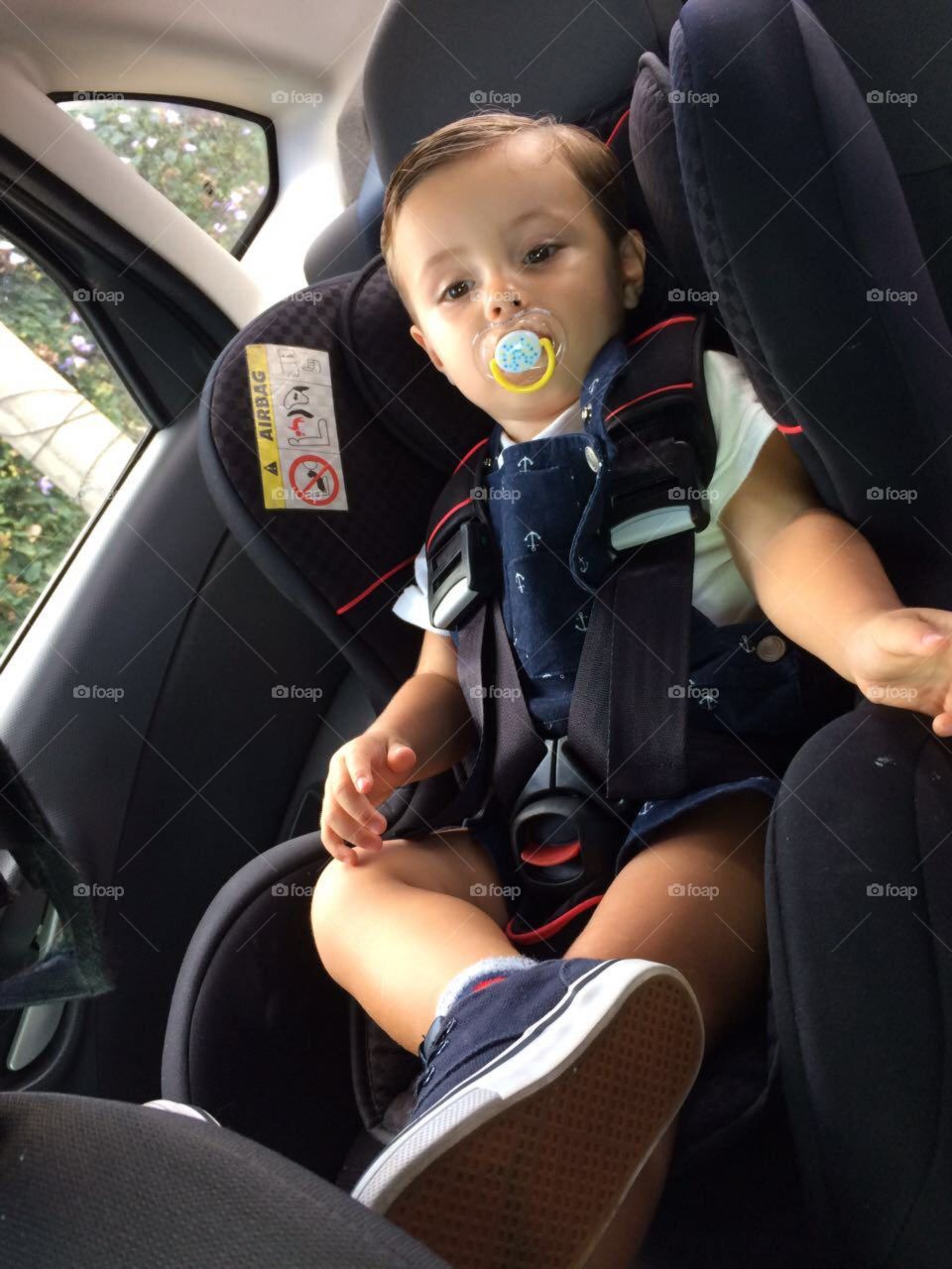 Child in the car seat in the car