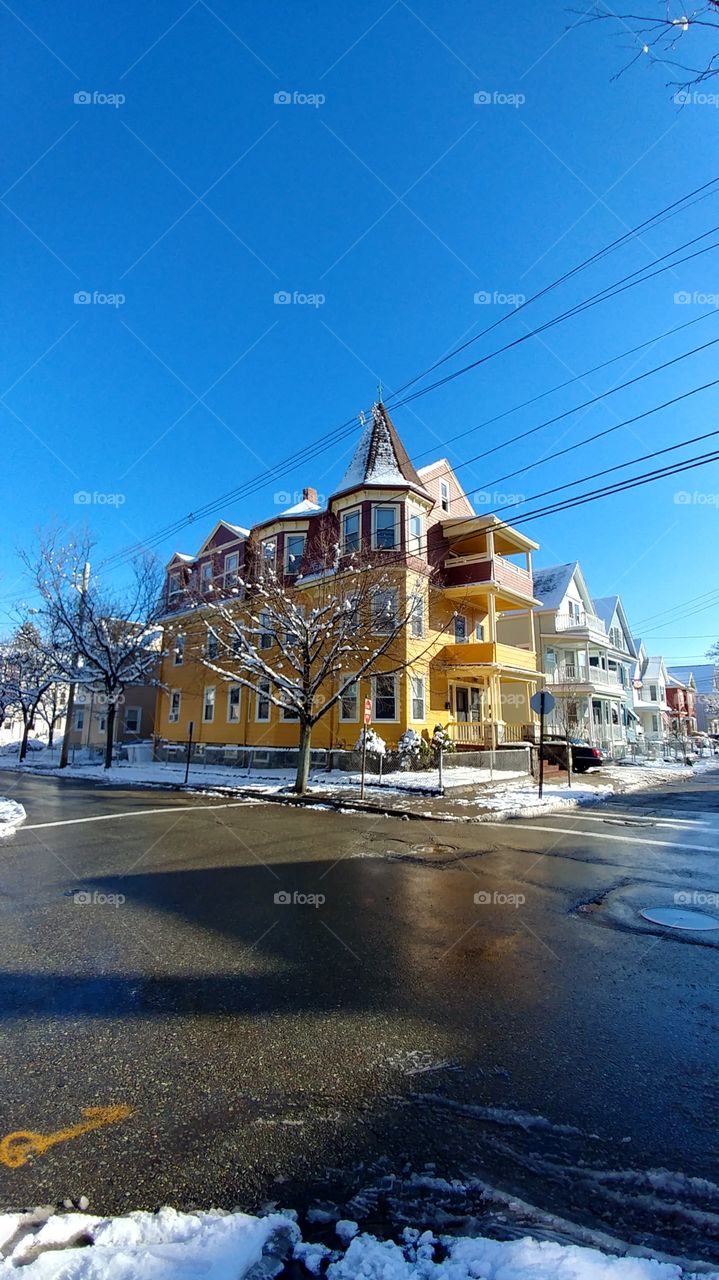 Yellow apartment complex in Boston Massachusetts after snow