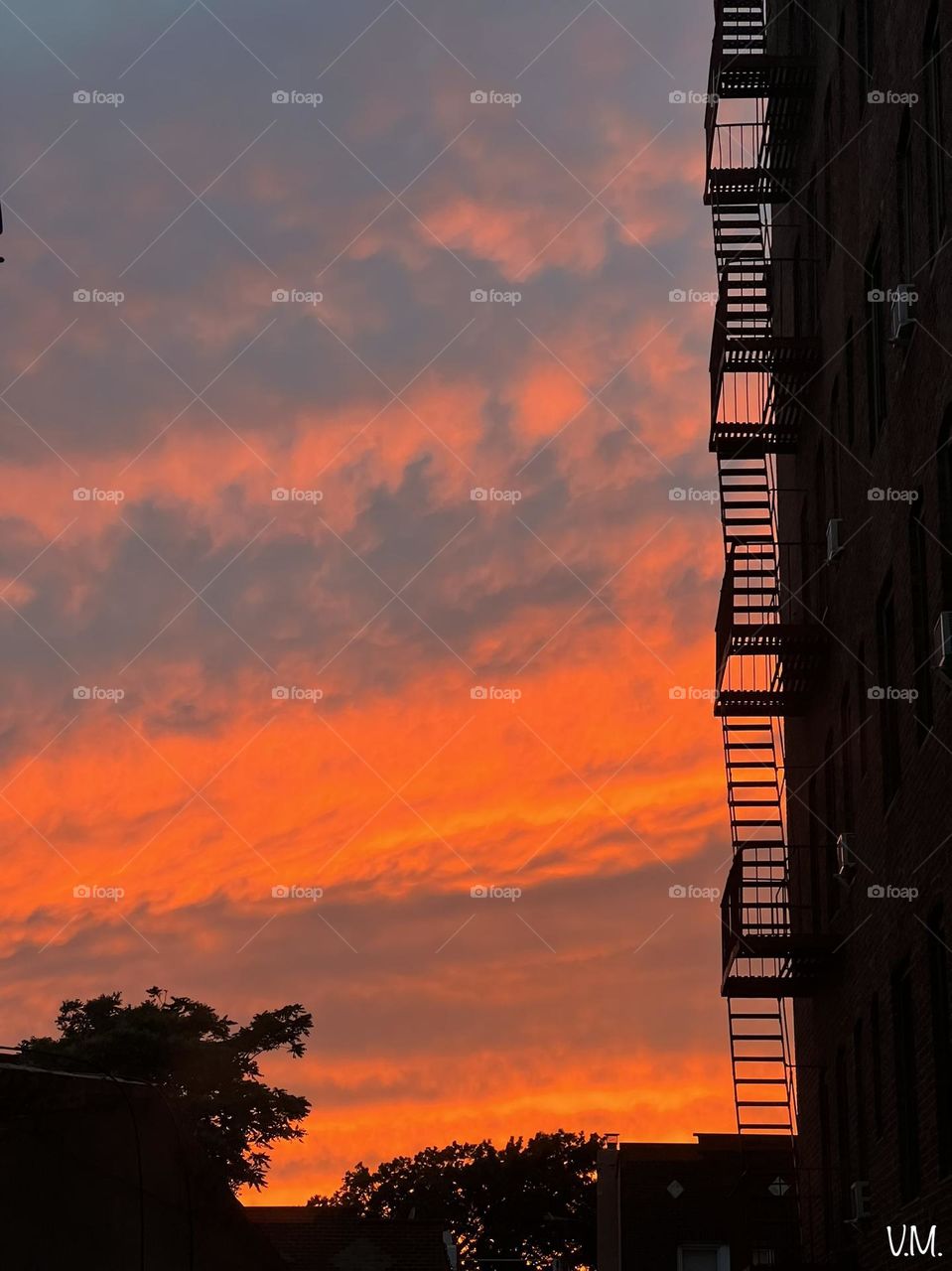 Bright city sunset with fire escapes