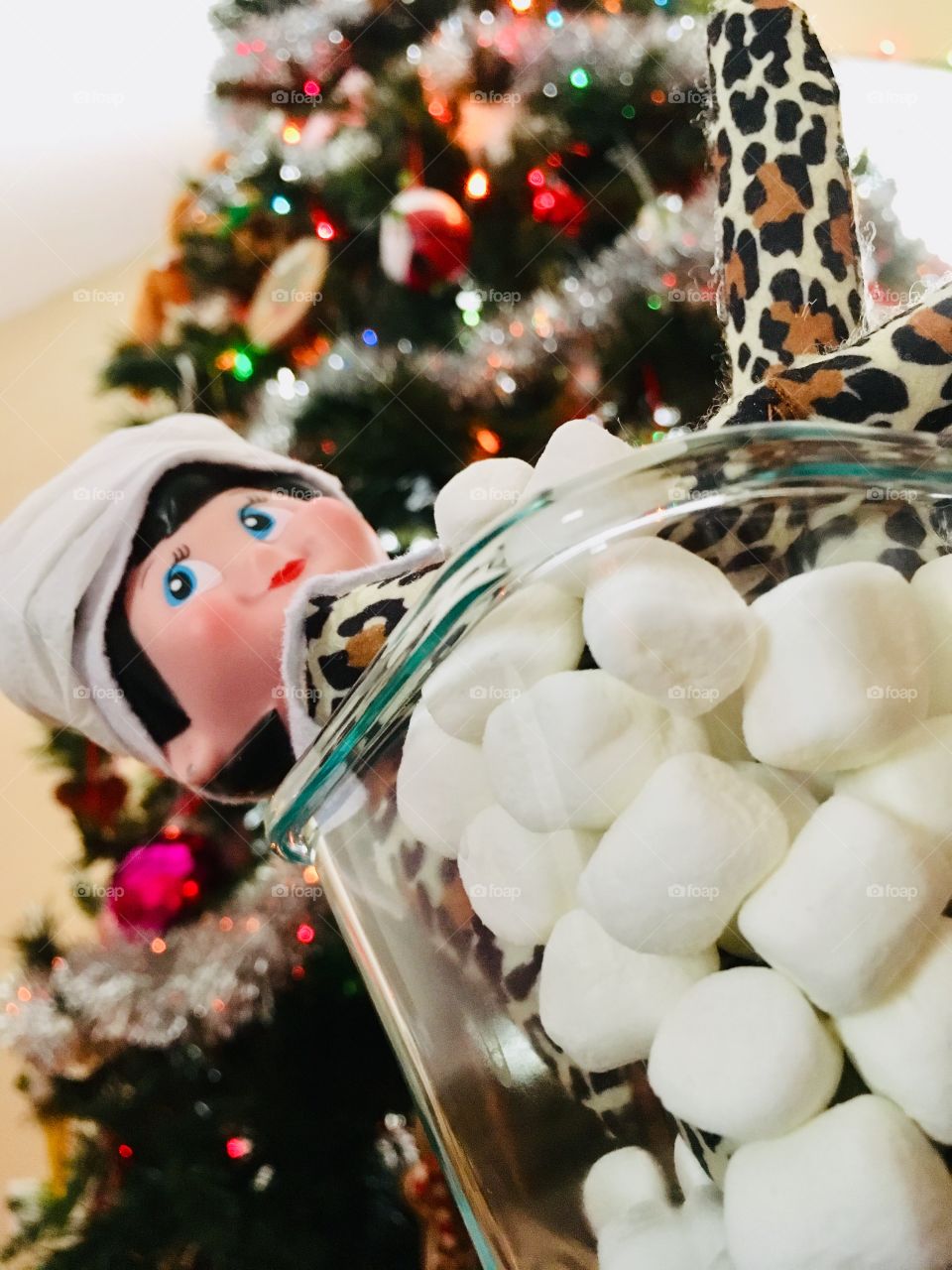 Naughty elf taking a bubble bath with marshmallows 