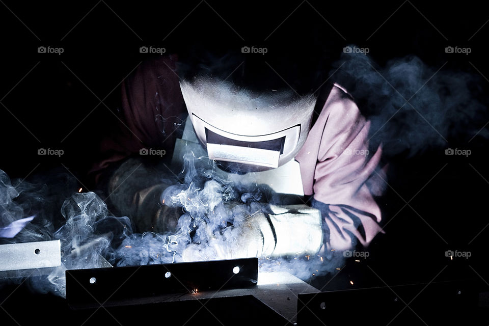 Welder worker closeup un mask