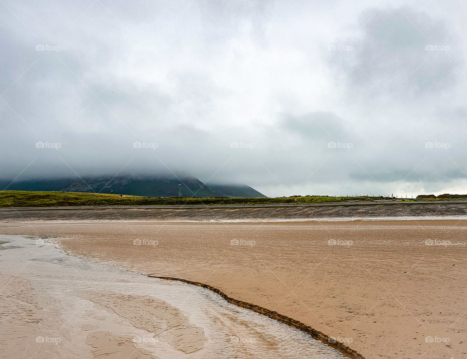 misty beach with mountain background