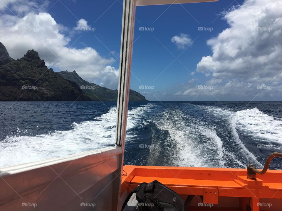 From a boat : Summer light on the sea with Marquisas islands silhouette 