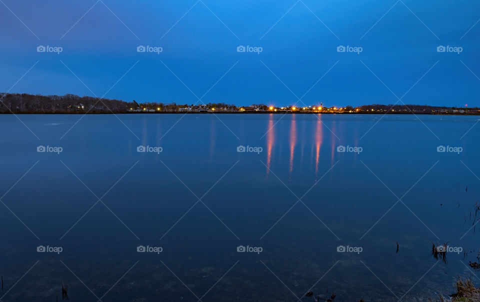 Water reflection of the deep. Beautiful lake and sky view with some light reflections. 