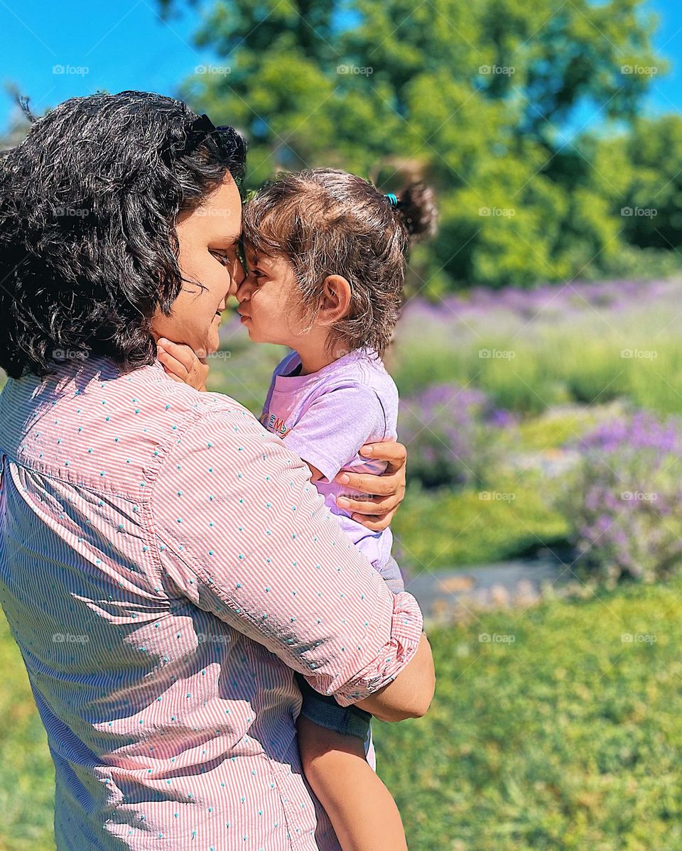 Mother and daughter in lavender field, snuggling with mommy, loving mommy, tender moments in nature, outside with children 