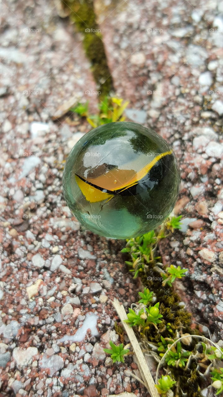 Closeup of glass marble on ground