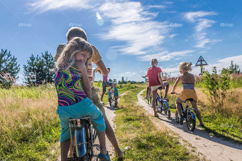 Children ride bikes on the countryside