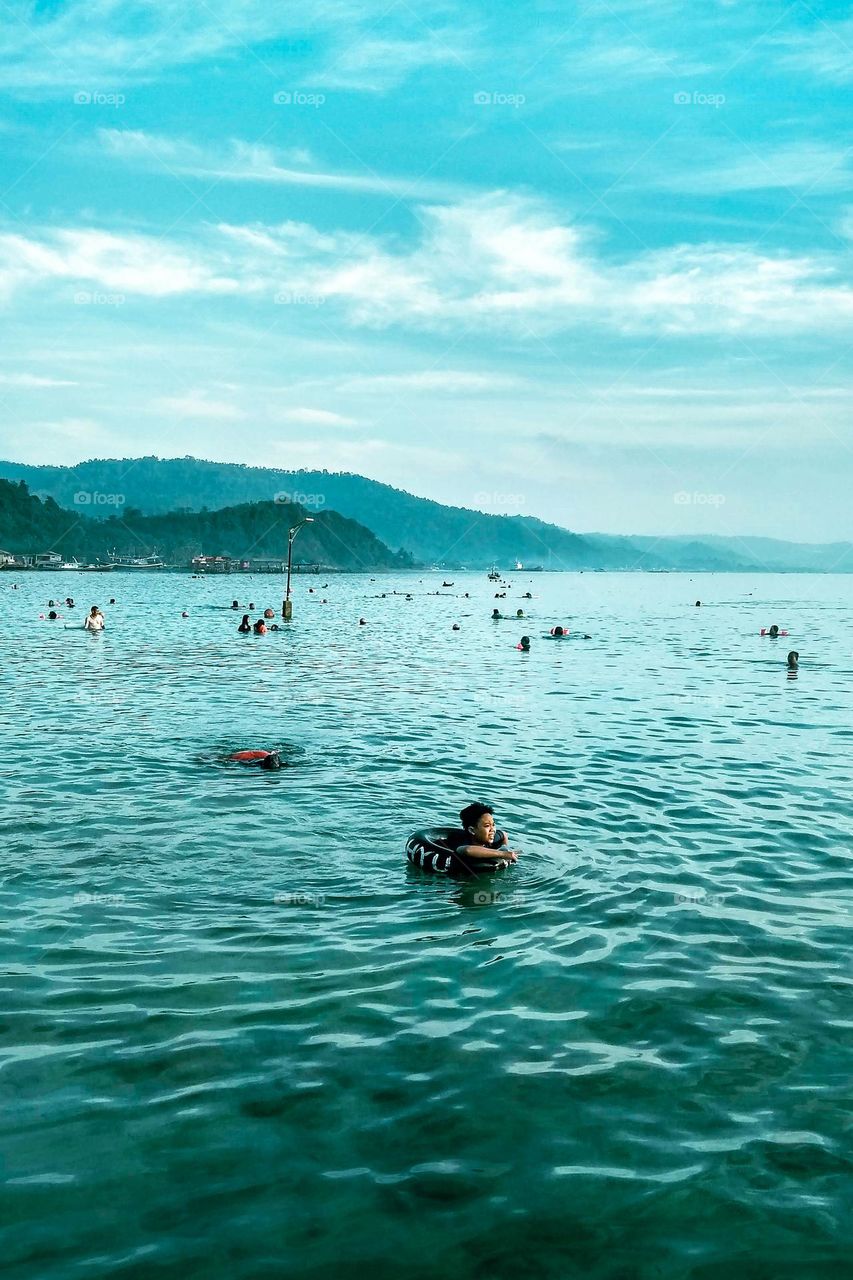 Bandar Lampung, Lampung, Indonesia - October 11, 2023: Visitors are enjoying the beauty of the beach at Lampung, Indonesia