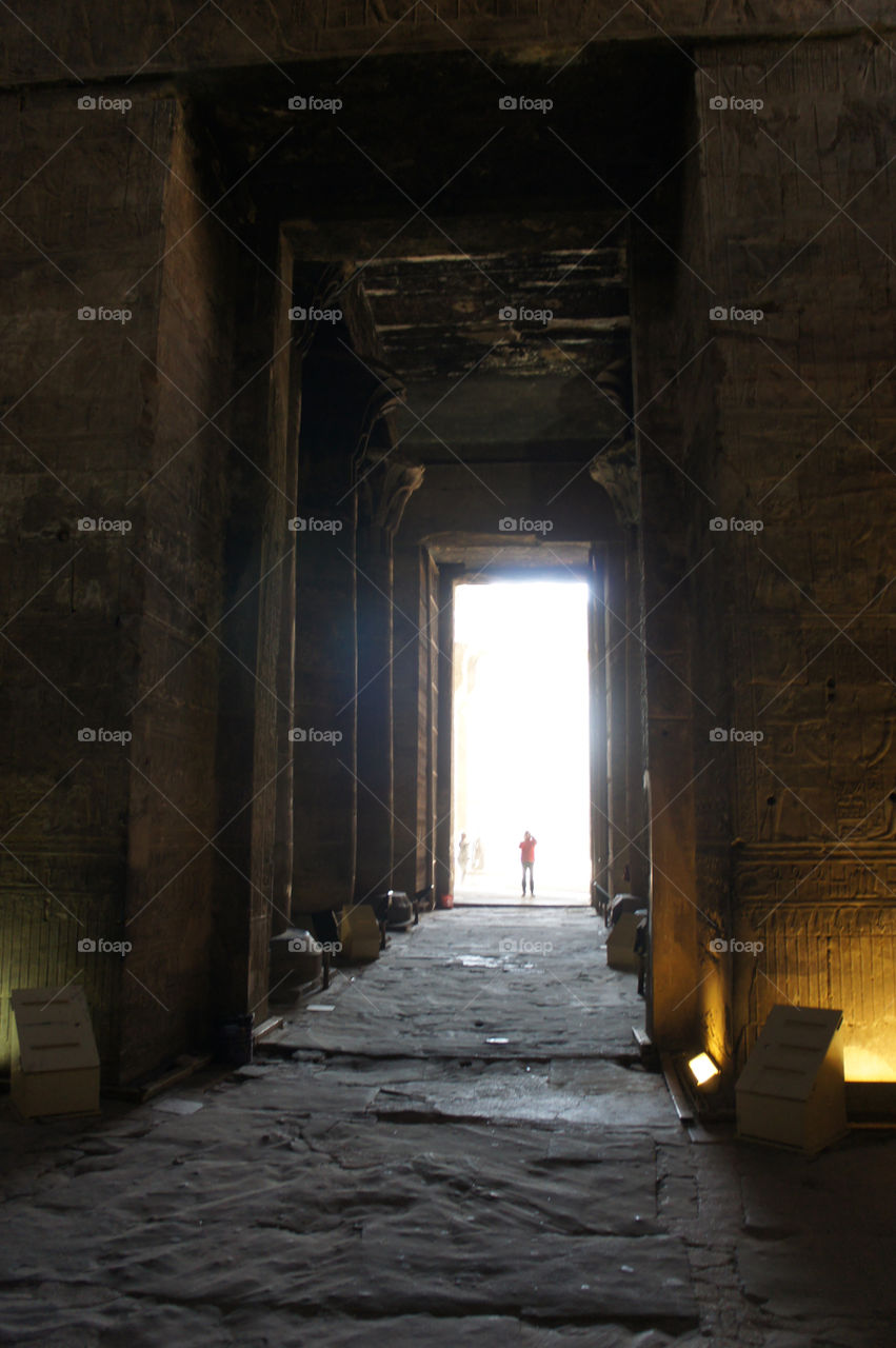 Light circles a tourist in an Egyptian ruin