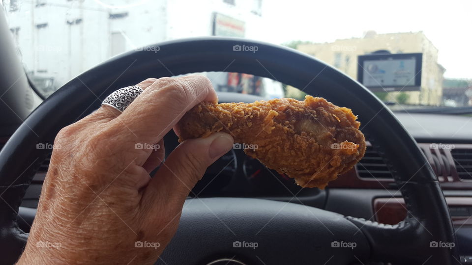 holding fried chicken leg