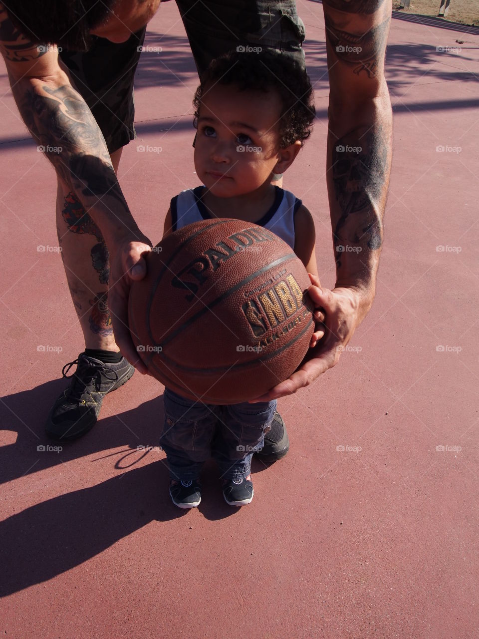 Father and son with basketball in hand