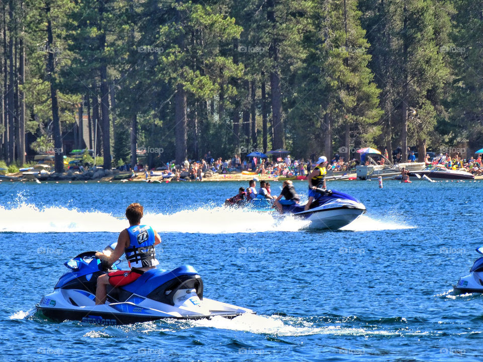 Jet skis and various watercraft on a lake