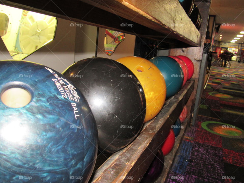Bowling balls sitting on a shelf