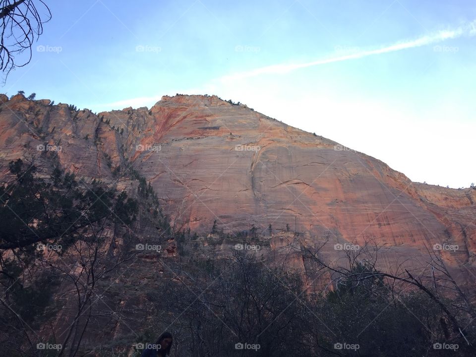 Sheer cliff of red rock.