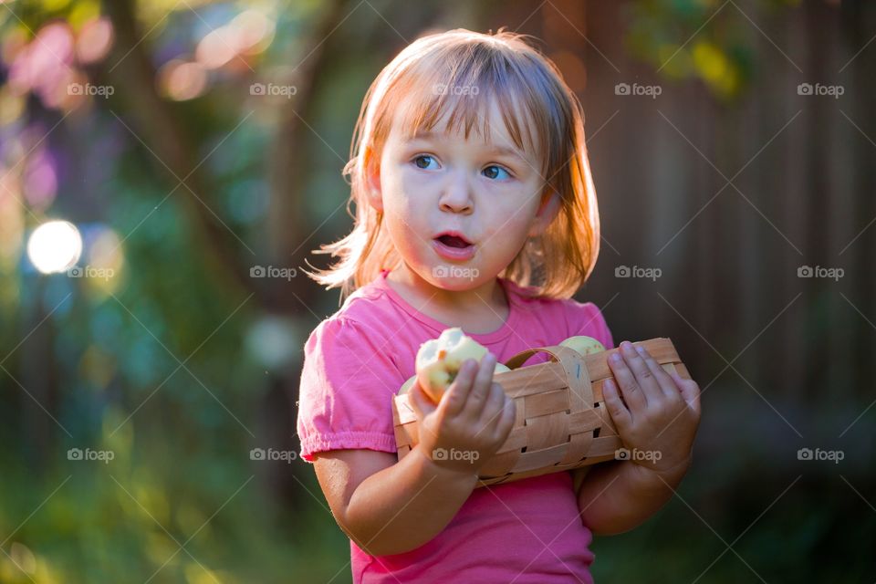 Little girl with basket of apple 