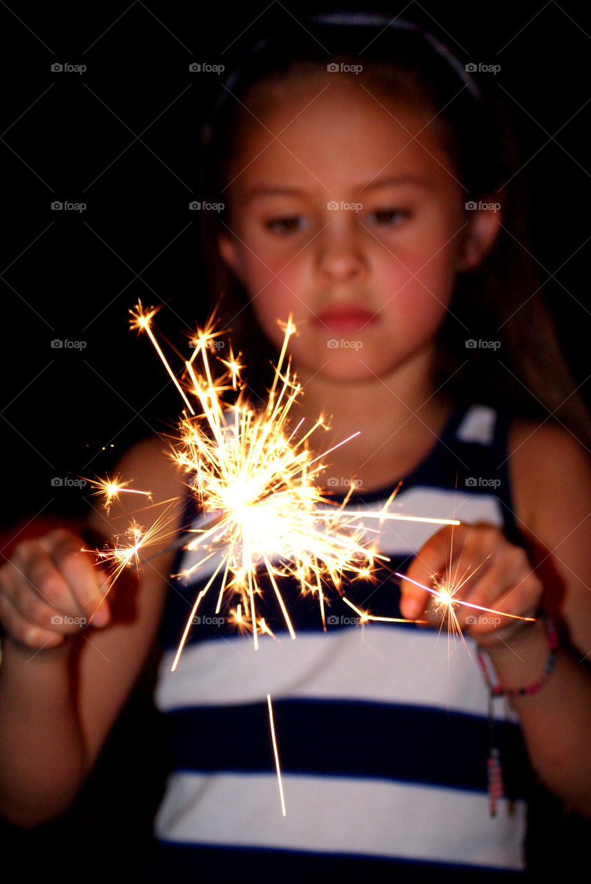 Girl holding sparklers in hand