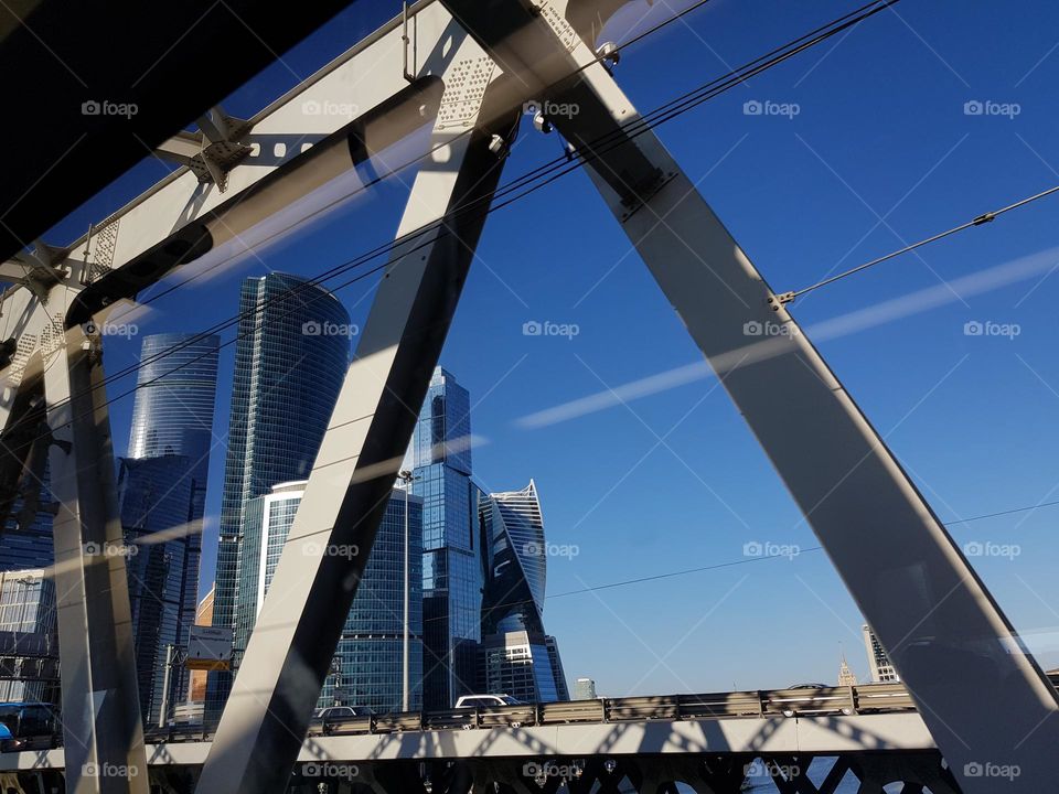 View on shiny, modern skyscrapers from a steel bridge