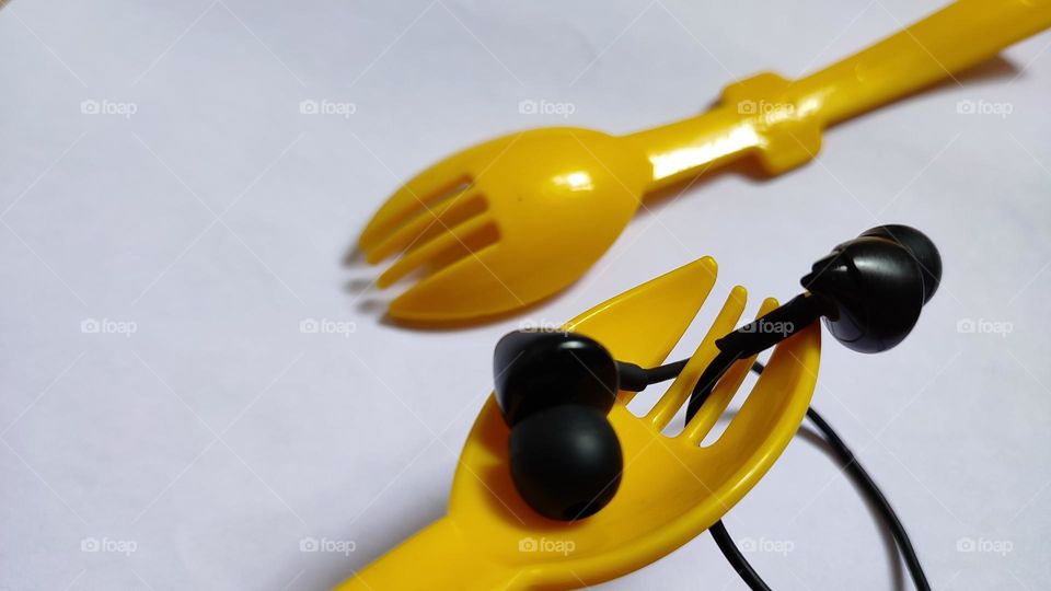 Yellow forks Trying to grab some music with earphones