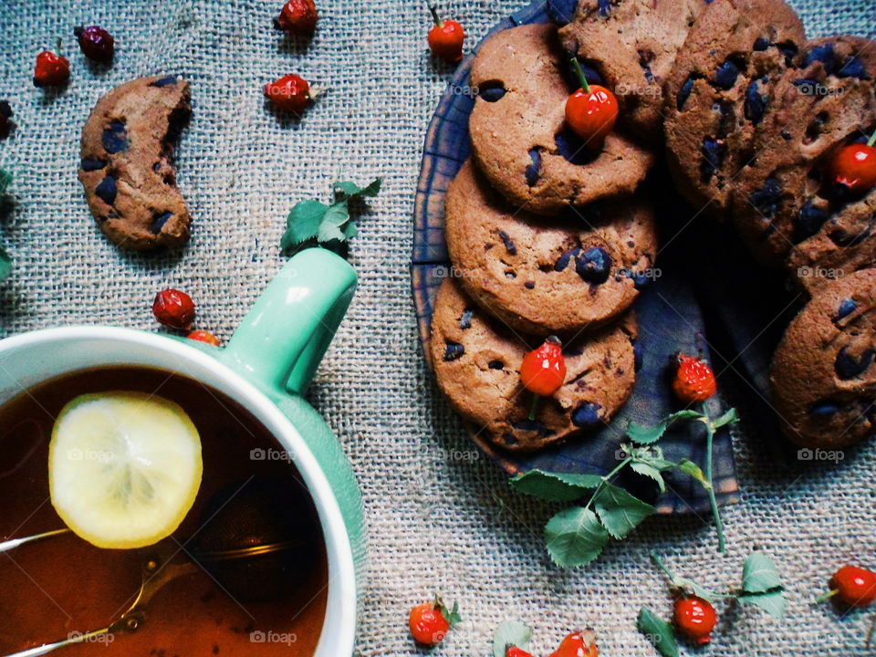 oatmeal cookies with chunks of chocolate and a cup of tea, dessert