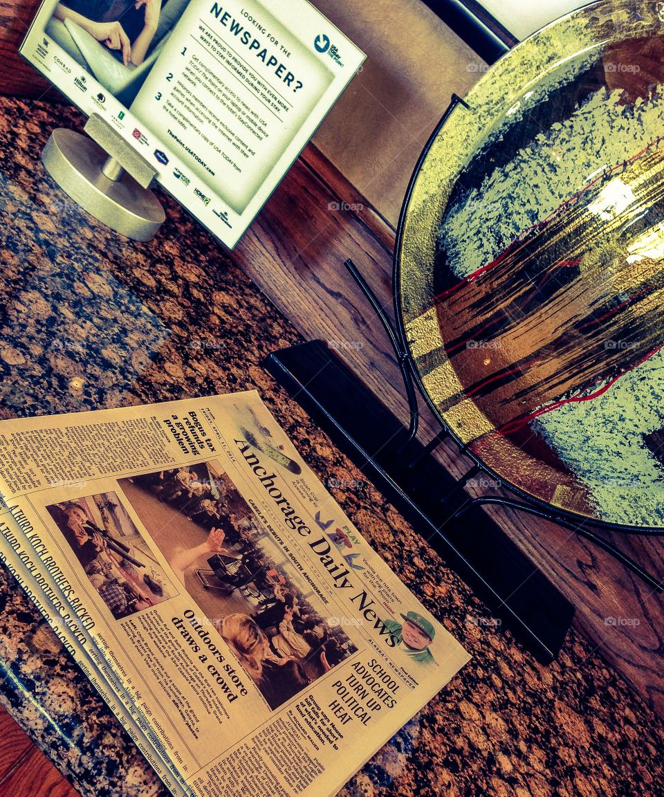 Up to date . Newspaper on top of a desk 