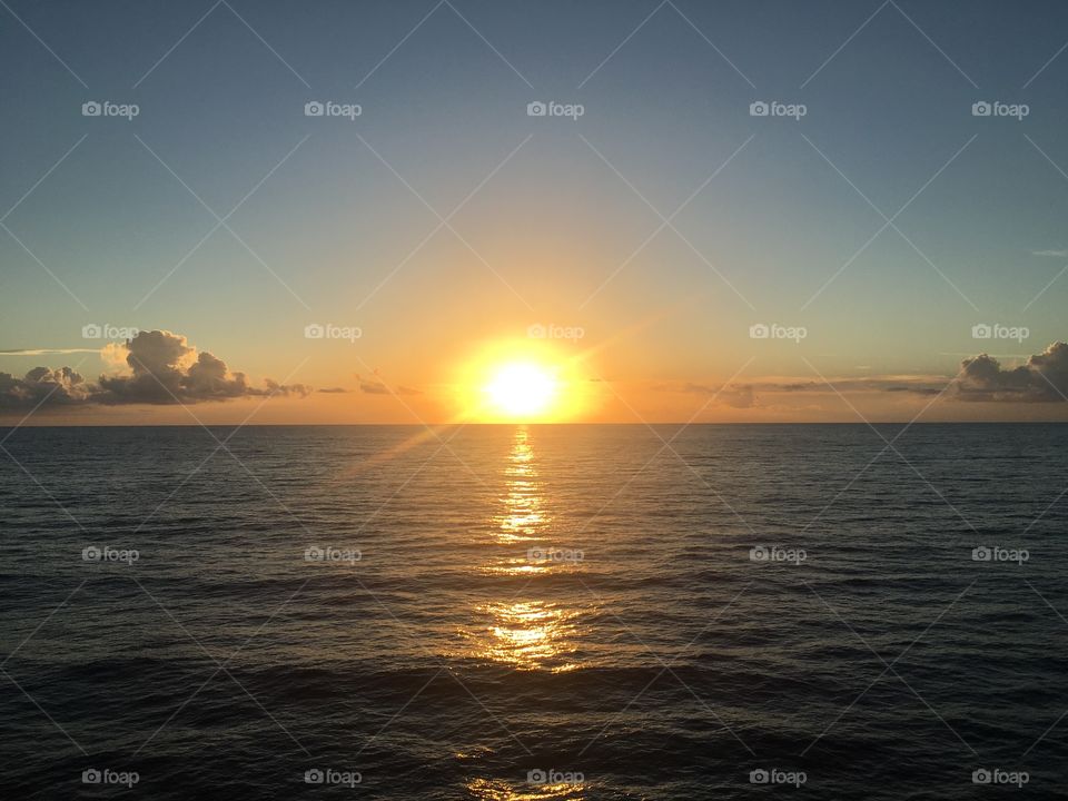 The sunset sets on the west coast, as we are looking over the Atlantic Ocean. The waves and its waters gleaming from the sun’s rays as it dips behind the horizon. The clouds wave goodbye as the sun disappears behind the horizon. 
